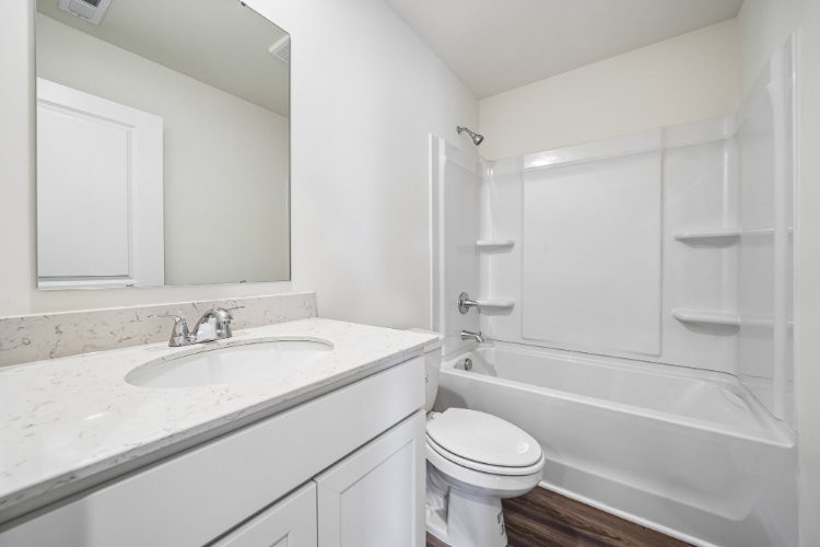 A bathroom with a sink toilet and bathtub.