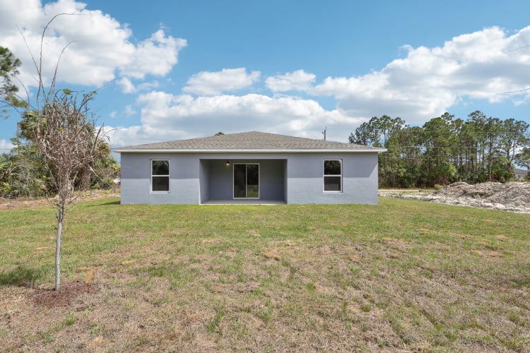 A white house in a field.