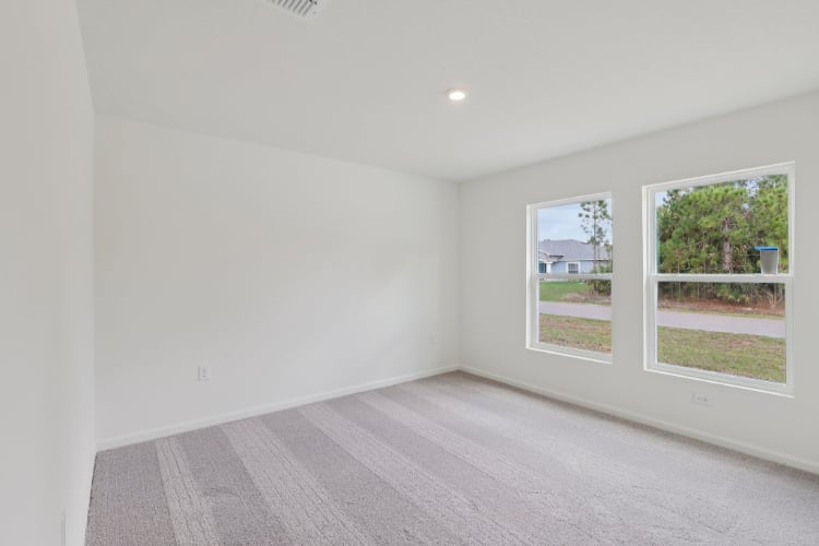 A room with a wood floor and windows.