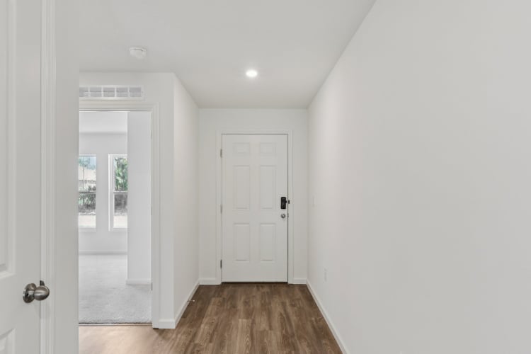 A hallway with white doors.