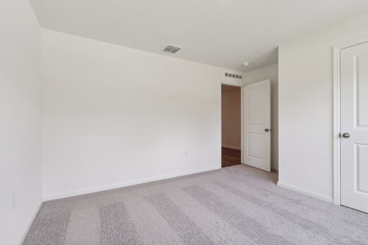 A hallway with white doors.