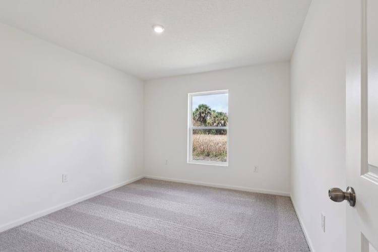 A room with a window and a door.