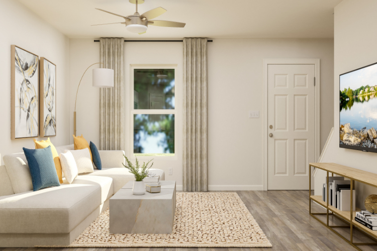 A living room with a white couch and a fan.