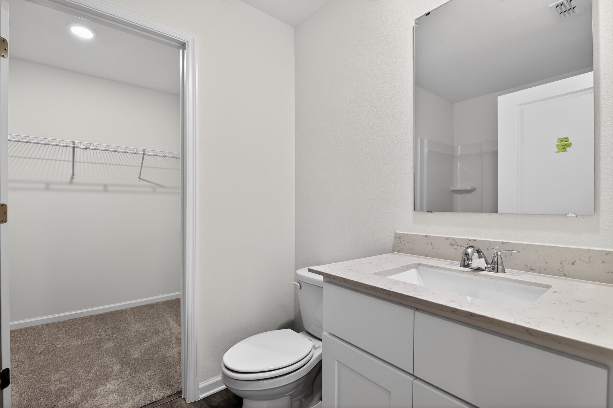 A bathroom with a toilet sink and shower.