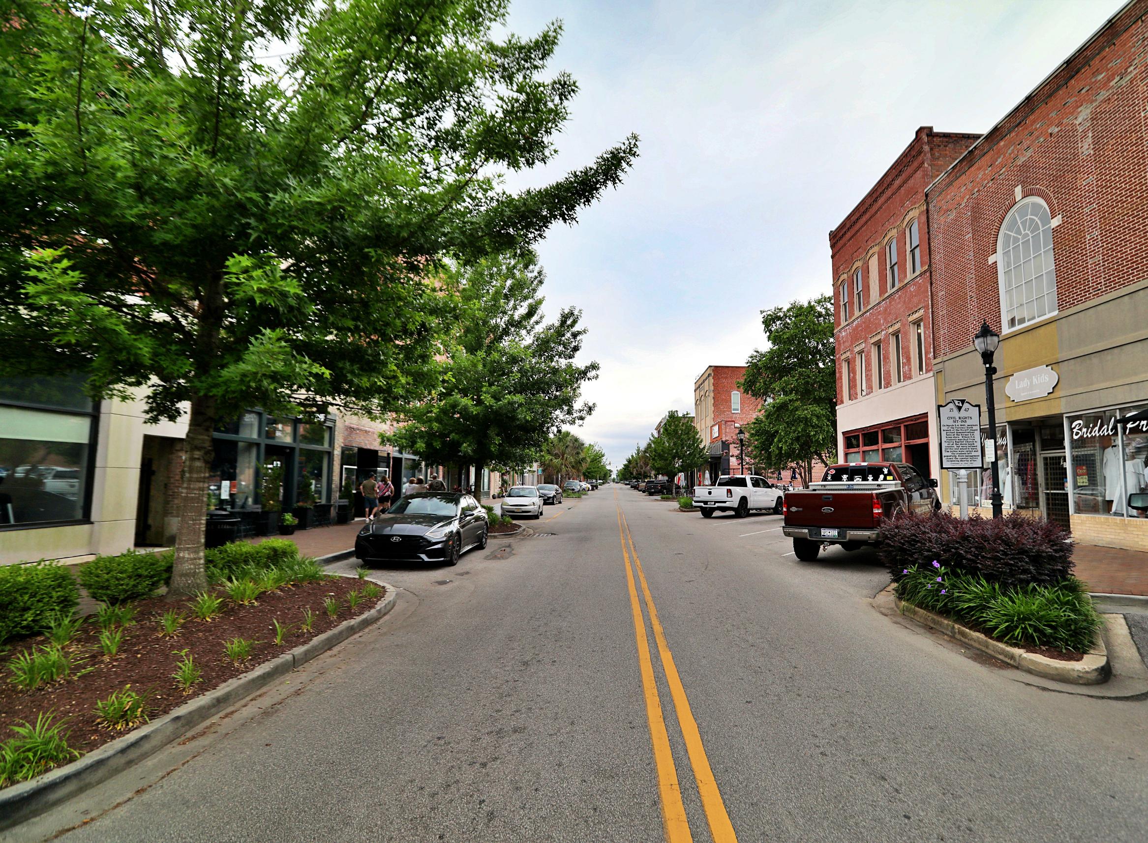 A street with cars and buildings on the side.