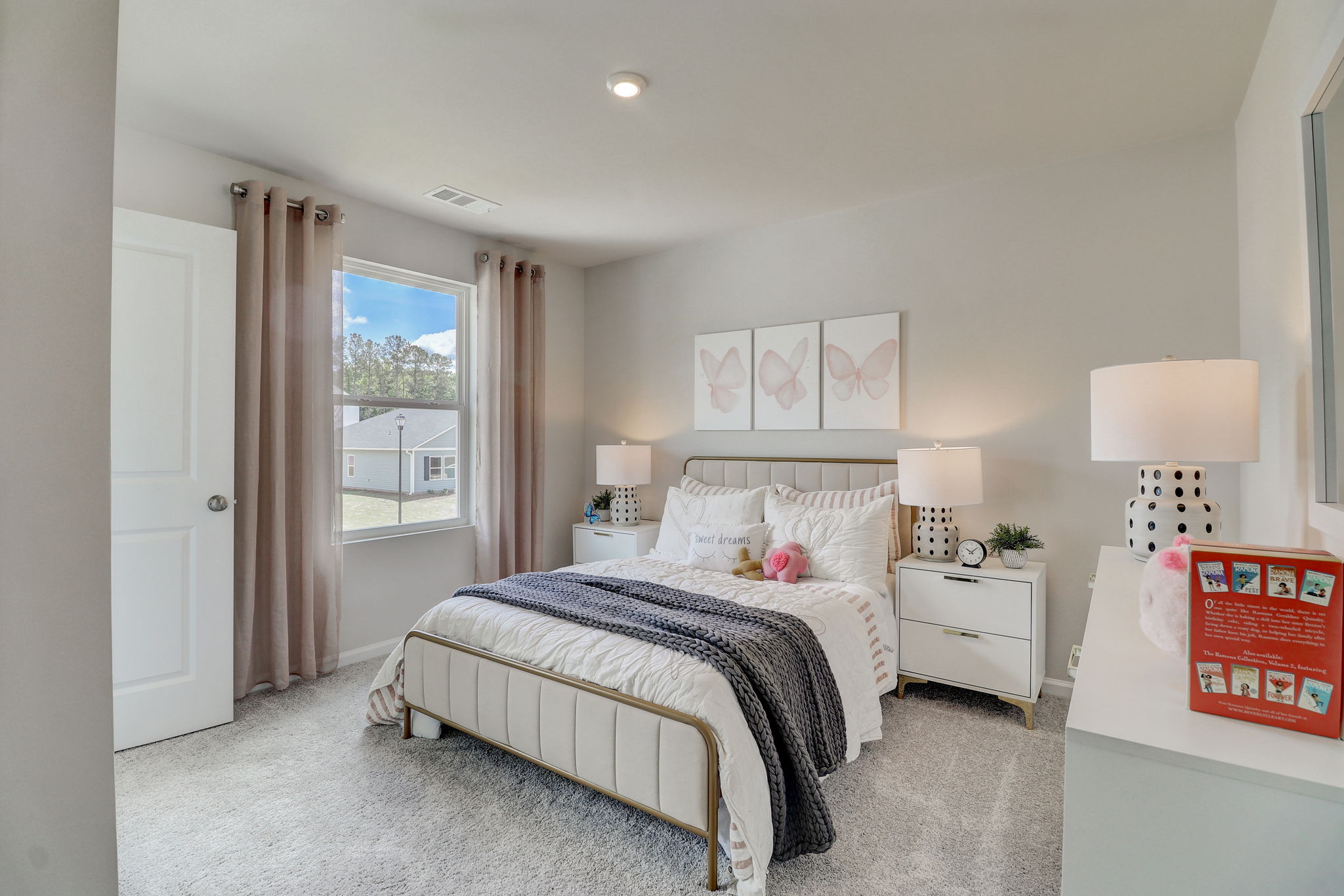 A bedroom with a large window.