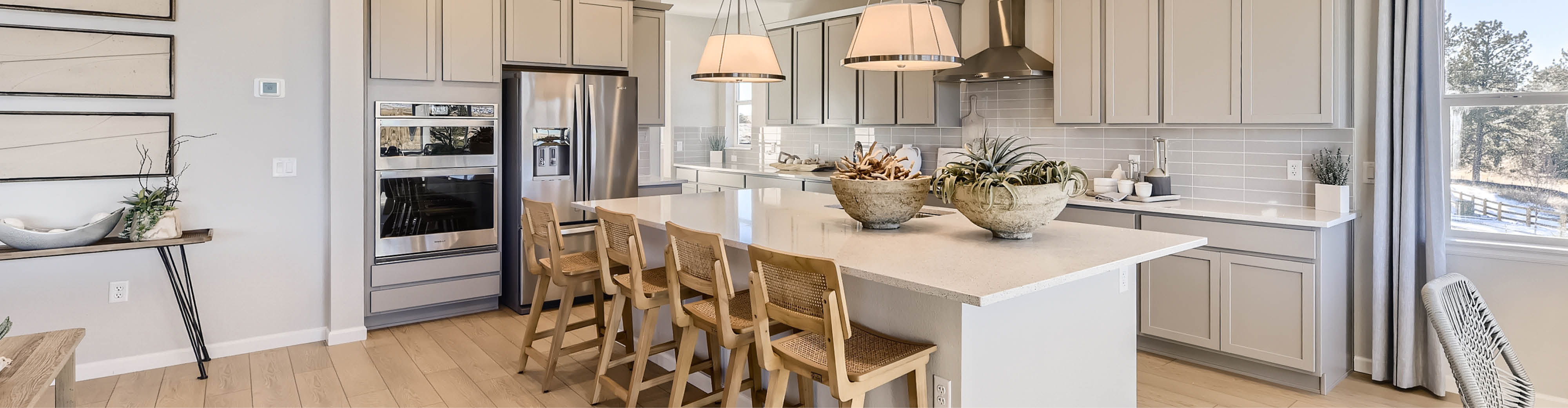 A kitchen with a dining table and chairs.