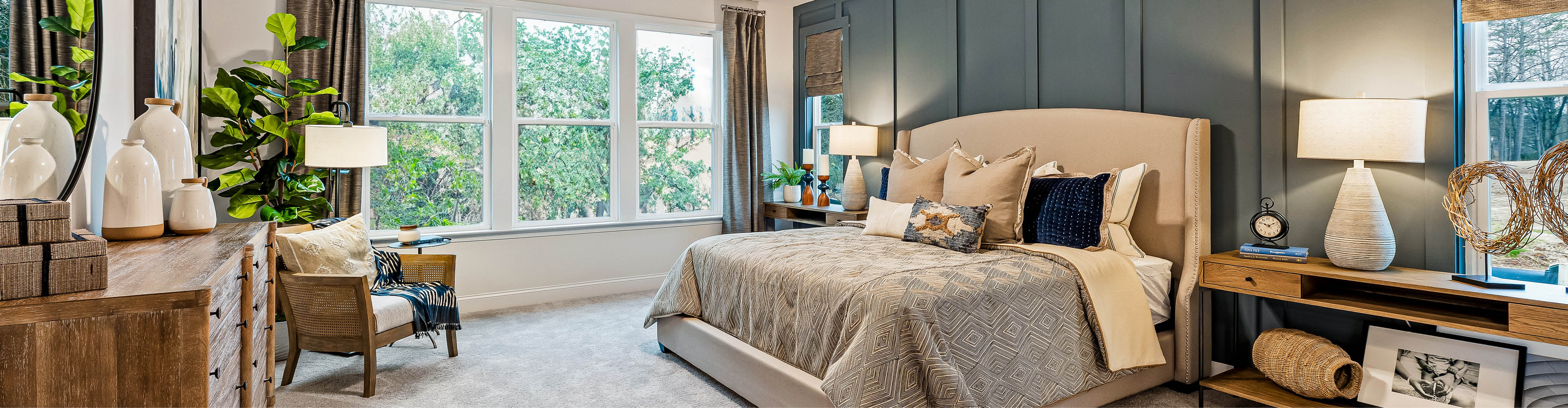 A bedroom with a bed and chairs.