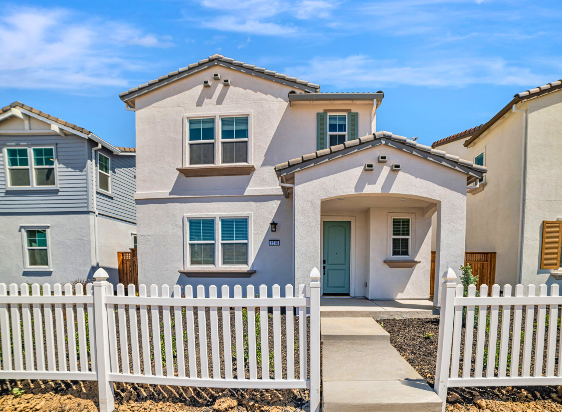 A white house with a fence.